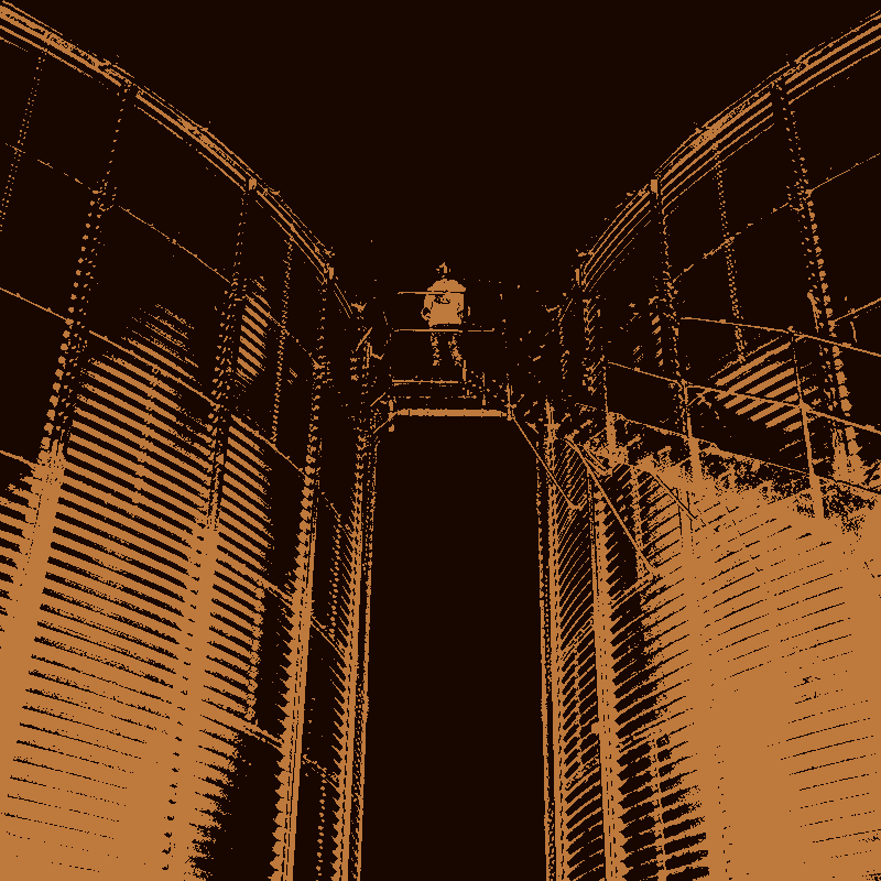 Man standing atop two silos